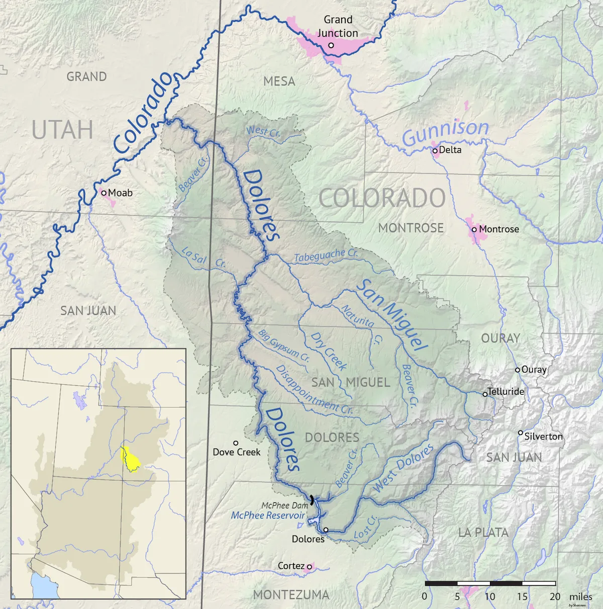 A shaded relief map of western Colorado and eastern Utah traces the Dolores River basin in bold blue, with major tributaries, town labels, and county names marked across the terrain. An inset map at lower left highlights the basin’s location within the broader region.