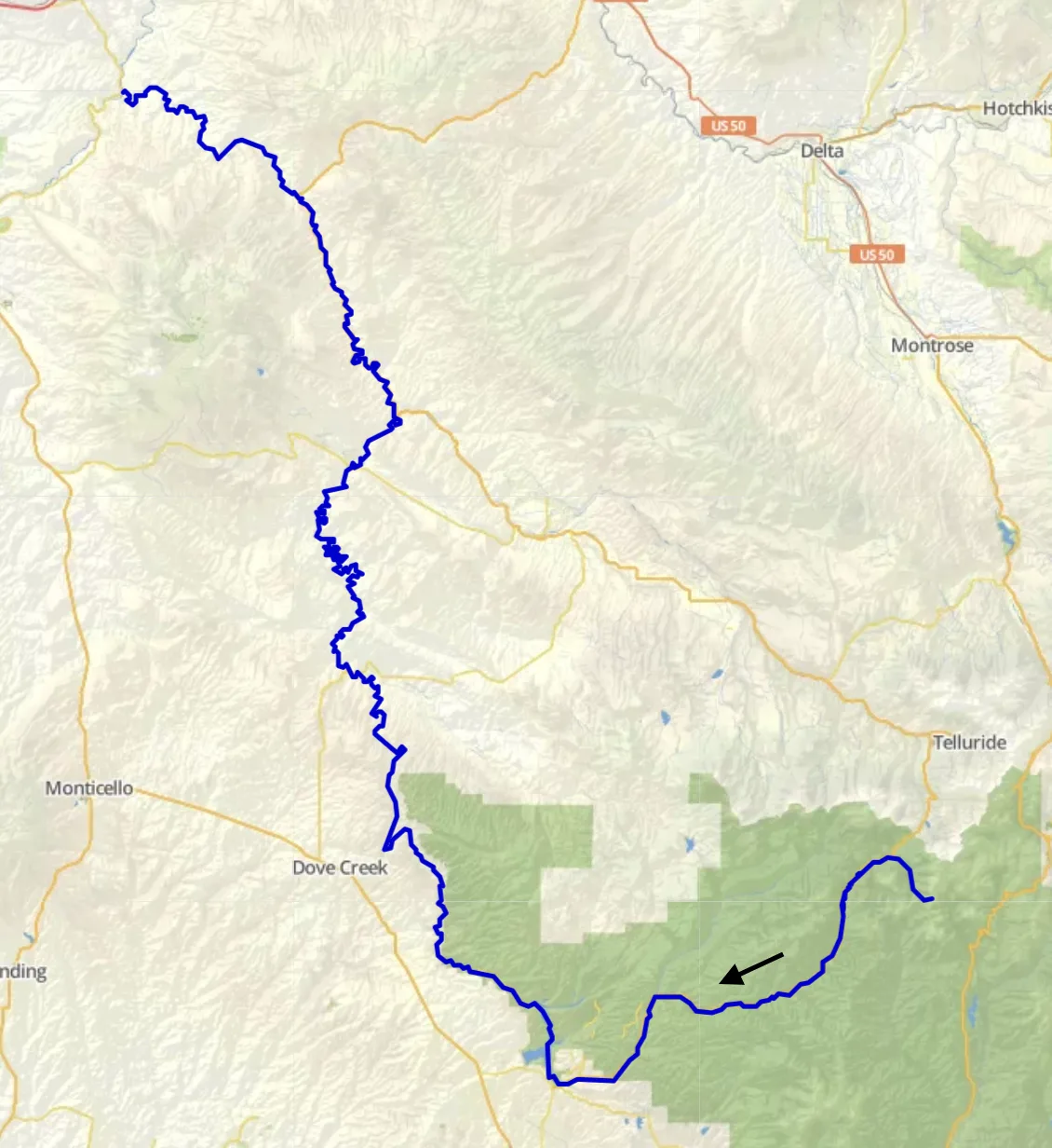A map view traces the Dolores River in a thick blue line through southwestern Colorado, with the highlighted section winding past Dove Creek toward the canyon near Dolores. The route cuts across pale, shaded terrain and green forested areas, with nearby town labels like Montrose, Telluride, and Delta visible.