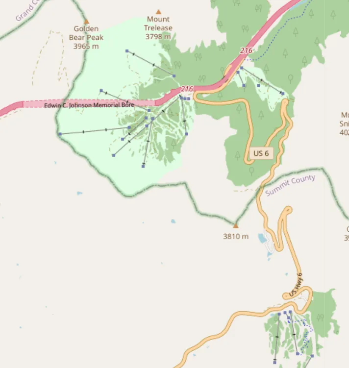 A map view of Loveland Pass shows US 6 winding over the Continental Divide between Summit County and Clear Creek County, with nearby peaks like Golden Bear Peak and Mount Trellease labeled. The route curves through steep alpine terrain and open high-elevation tundra, emphasizing the pass’s rugged, snowy mountain setting.