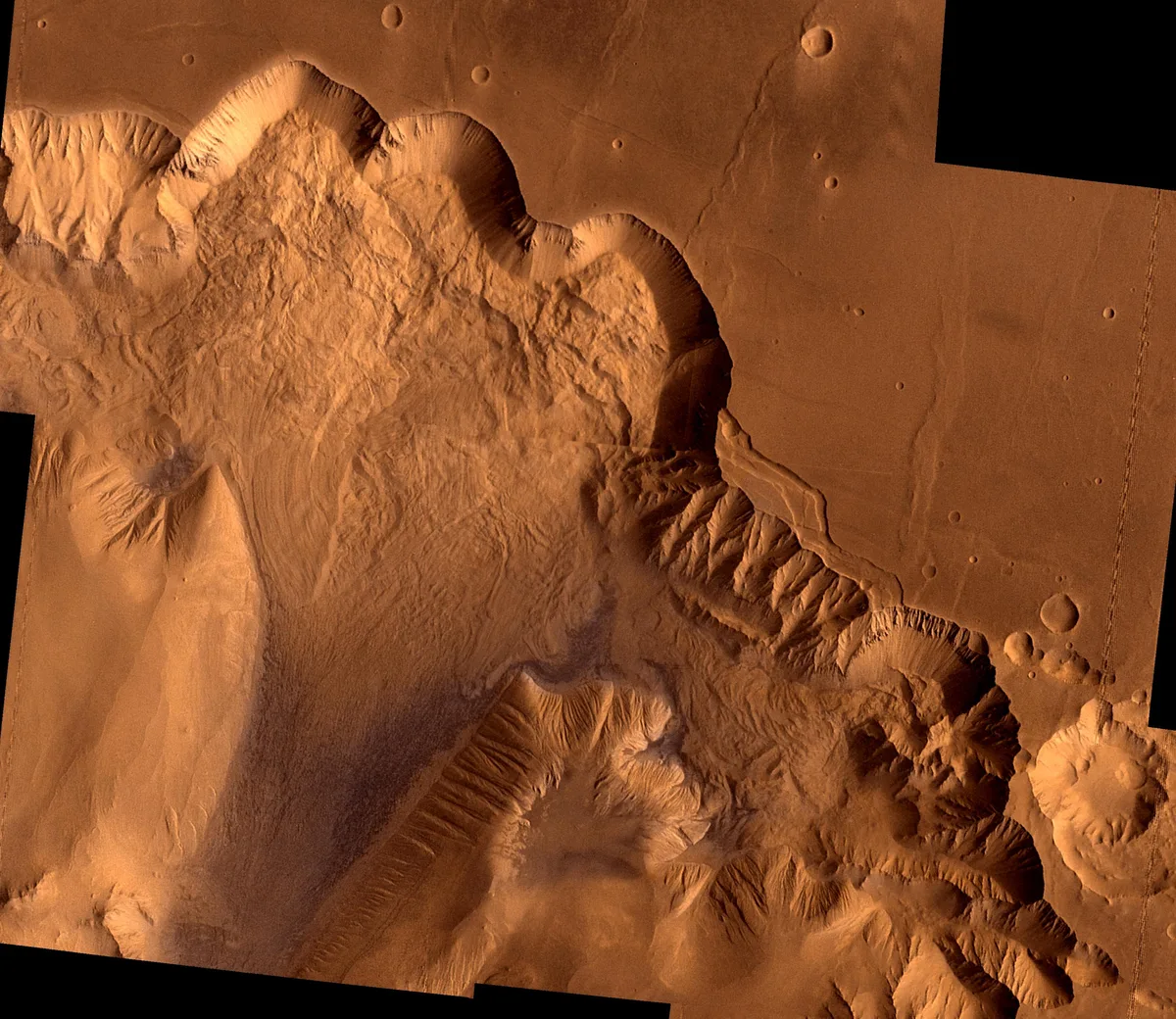 A rust-colored aerial landscape of eroded canyons and ridges fills the frame, with steep scalloped cliffs casting deep shadows across the surface. Smooth, pitted plains at the top and right edge contrast with the rough, wind-carved terrain below.